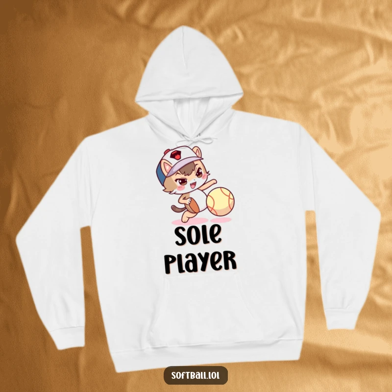 Funny hoodie with a mischievous character dribbling a softball with its foot, showing playful skill.