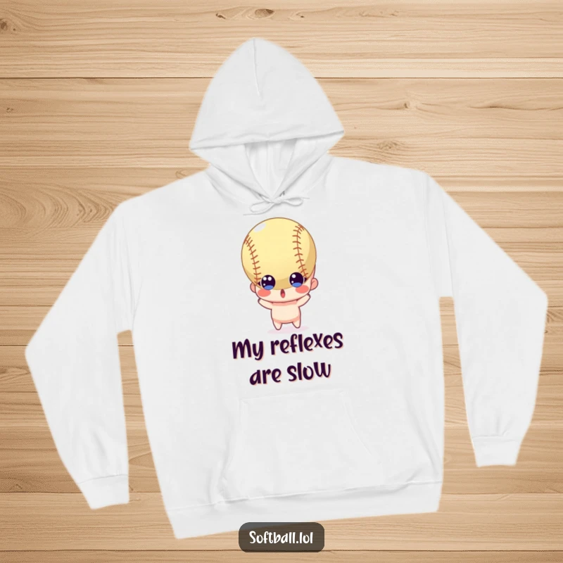 Funny hoodie depicting a surprised character with wide eyes reacting to a softball flying towards it, offering warmth and humor.